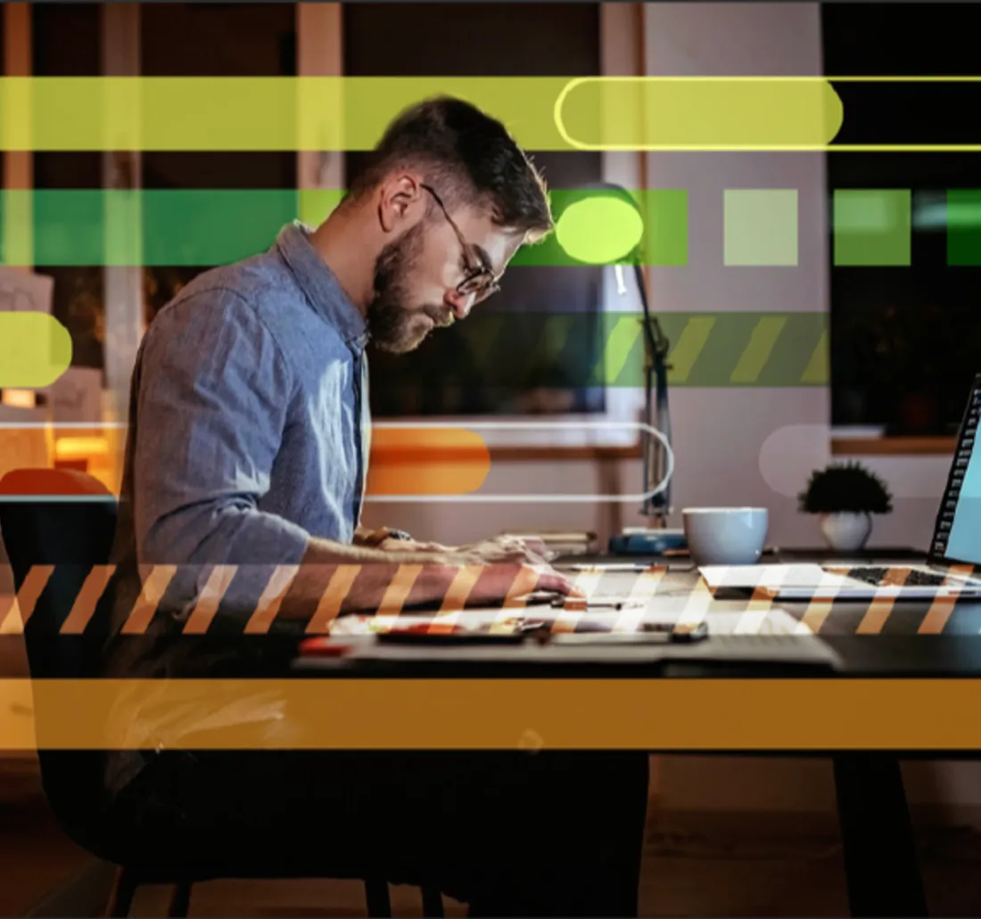 An AEC professional reviewing plans on a laptop